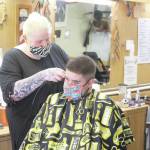 Photo by Brian Mazurek/Peninsula Clarion                                Skylar Giordano cuts Ryan Huertas hair at RDs Barber Shop in Kena on Thursday. RDs is one of the 186 local businesses and nonprofits in Kenai that already received financial assistance through the City of Kenais Grant Program.