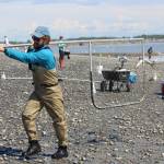Shawn Dick of Talkneetna carries a fresh catch out of the water while dipnetting on the Kenai Beach on July 10, 2020. (Photo by Brian Mazurek/Peninsula Clarion)