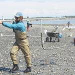 Brian Mazurek / Peninsula Clarion                                Shawn Dick of Talkneetna carries a fresh catch out of the water while dipnetting on the Kenai Beach on Friday.