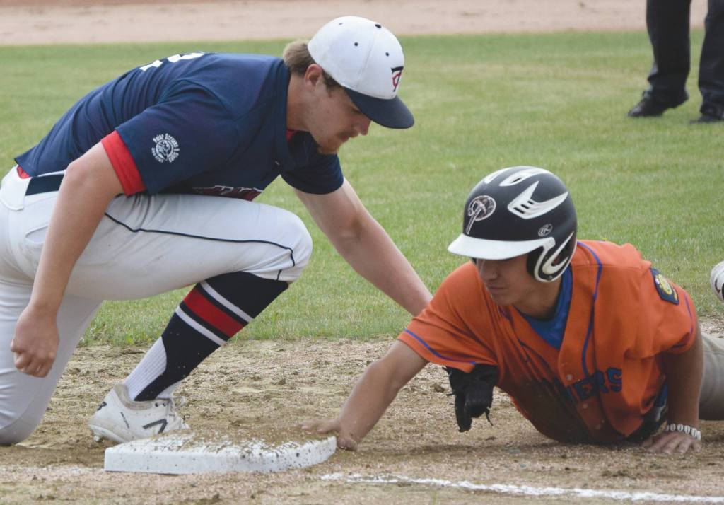 Alaska 20 first baseman Tanner Ussing applies a late tag to Palmers Drake Gallagher on Saturday, July 11, 2020, at the Soldotna Little League fields in Soldotna, Alaska. (Photo by Jeff Helminiak/Peninsula Clarion)