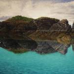 David Pettibones Reflection shows Gull Island, as seen on July 7, 2020, at Bunnell Street Arts Center in Homer, Alaska. (Photo by Michael Armstrong/Homer News)