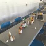 A plexiglass shield divides a dining room table into six, doubling the dining capacity of the table, Tuesday, July 14, 2020, at Pacific Star Seafoods in Kenai, Alaska. (Photo by Jeff Helminiak/Peninsula Clarion)