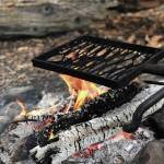 Embers ideal for cooking smores smolder away on June 27, 2020 at a campsite along the Resurrection Pass Trail in Cooper Landing, Alaska. (Photo by Megan Pacer/Homer News)