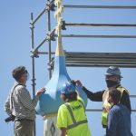 Grant Crosby, a National Park Service historical architect; Russel Guernsey, with Blazy Construction; Randall Nelson, with Blazy Construction; and John Wechtel, a National Park Service historical architect, examine the Holy Assumption of the Virgin Mary Russian Orthodox Church on Monday, July 20, 2020, in Kenai, Alaska. (Photo by Jeff Helminiak/Peninsula Clarion)