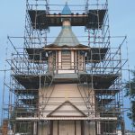 Photos by Jeff Helminiak/Peninsula Clarion                                Scaffolding is erected at the Holy Assumption of the Virgin Mary Russian Orthodox Church on Wednesday, July 15 in Kenai. Above, Dorothy Gray displays the contents of a time capsule found Monday, on the first day of the improvement project, in Kenai on Monday.