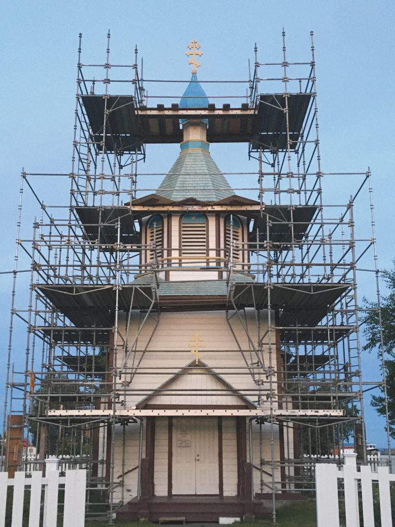 Photos by Jeff Helminiak/Peninsula Clarion                                Scaffolding is erected at the Holy Assumption of the Virgin Mary Russian Orthodox Church on Wednesday, July 15 in Kenai. Above, Dorothy Gray displays the contents of a time capsule found Monday, on the first day of the improvement project, in Kenai on Monday.