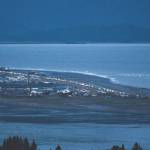 Headlights from a line of cars shine at dusk as people evacuate the Spit in Homer, Alaska, following a powerful earthquake in the Aleutian Islands that prompted a tsunami warning. There were no immediate reports of damage in the sparsely populated area of the state, and the tsunami warning was later canceled. (Pat Williams Russell via AP)