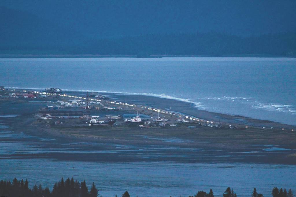 Headlights from a line of cars shine at dusk as people evacuate the Spit in Homer, Alaska, following a powerful earthquake in the Aleutian Islands that prompted a tsunami warning. There were no immediate reports of damage in the sparsely populated area of the state, and the tsunami warning was later canceled. (Pat Williams Russell via AP)