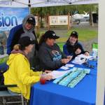 From left, Monique Burgin, Shanon Davis, Teresa Honrud and Sara Hondel of the Soldotna Chamber of Commerce add up the total amount of money spent as part of the Chambers Soldotna Strong Shop Local campaign during Progress Days in Soldotna Creek Park on July 22, 2020. (Photo by Brian Mazurek/Peninsula Clarion)