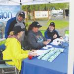 From left, Monique Burgin, Shanon Davis, Teresa Honrud and Sara Hondel of the Soldotna Chamber of Commerce on Wednesday add up the money spent as part of the Chambers Soldotna Strong Shop Local campaign.