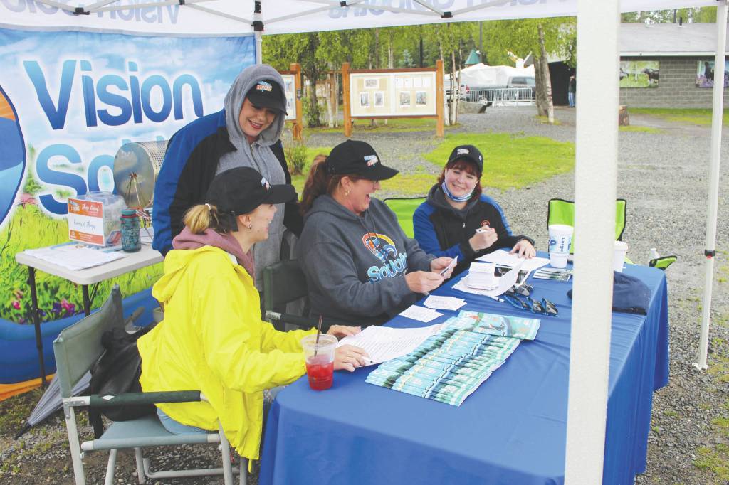 From left, Monique Burgin, Shanon Davis, Teresa Honrud and Sara Hondel of the Soldotna Chamber of Commerce on Wednesday add up the money spent as part of the Chambers Soldotna Strong Shop Local campaign.