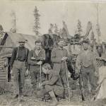 Ed Haun (kneeling) poses with a group of other hunters and several hanging quarters of moose meat, circa late 1910s. The structure may be the Hauns cabin near the Chickaloon River, referred to in a 1914 rangers diary. (Courtesy of the Hope and Sunrise Historical Society)