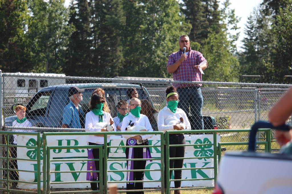 From left, JaLeen Gattenby, Jewel Meadow and Ndea Rollins show Meadows Grand Champion rabbits during the 4H Junior Market Drive-in Auction at the Soldotna Rodeo Grounds on Aug. 15, 2020. (Photo by Brian Mazurek/Peninsula Clarion)