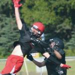 Kenai Central receiver Dave Martin and Nikiski defender Gavin White compete for the ball Saturday at the football jamboree at Ed Hollier Field at Kenai Central High School in Kenai, Alaska. (Photo by Jeff Helminiak/Peninsula Clarion)