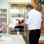 Photo by Megan Pacer/Homer News                                Homer Volunteer Fire Department Chief Mark Kirko collects his ballot during the primary election on Tuesday at the Homer Chamber of Commerce and Visitor Center polling location in Homer.