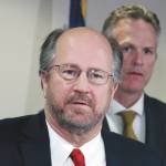 In this Sept. 26, 2019, file photo, Alaska Attorney General Kevin Clarkson, left, addresses reporters as Gov. Mike Dunleavy, right, looks on in Anchorage, Alaska. Clarkson has resigned, shortly after details of text messages that the states married and socially conservative top law enforcement officer sent to a female state employee were revealed Tuesday, Aug. 25, 2020. (AP Photo/Mark Thiessen, File)