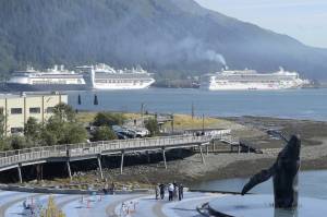 The Norwegian Pearl cruise ship, right, pulls into the AJ Dock in Juneau in September 2018. Emissions are among the many grievances raised by the Global Cruise Activist Network against the cruise industry. (Michael Penn / Juneau Empire File)