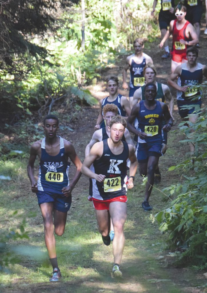 Soldotnas Maleda Denbrock and Kenai Centrals Maison Dunham battle early in the junior-senior boys race at the Nikiski Class Races on Friday, Sept. 4, 2020, at Nikiski High School in Nikiski, Alaska. (Photo by Jeff Helminiak/Peninsula Clarion)