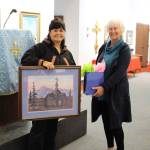 Sheri Buretta, the chairman of the board of the Chugach Alaska Corporation, presents a gift to Dorothy Gray, a lifelong member of the Holy Assumption of the Virgin Mary Russian Orthodox Church, during a celebration of the 125th anniversary of the church at the Kenai Visitor and Cultural Center on Sept. 4, 2020. (Photo by Brian Mazurek/Peninsula Clarion)