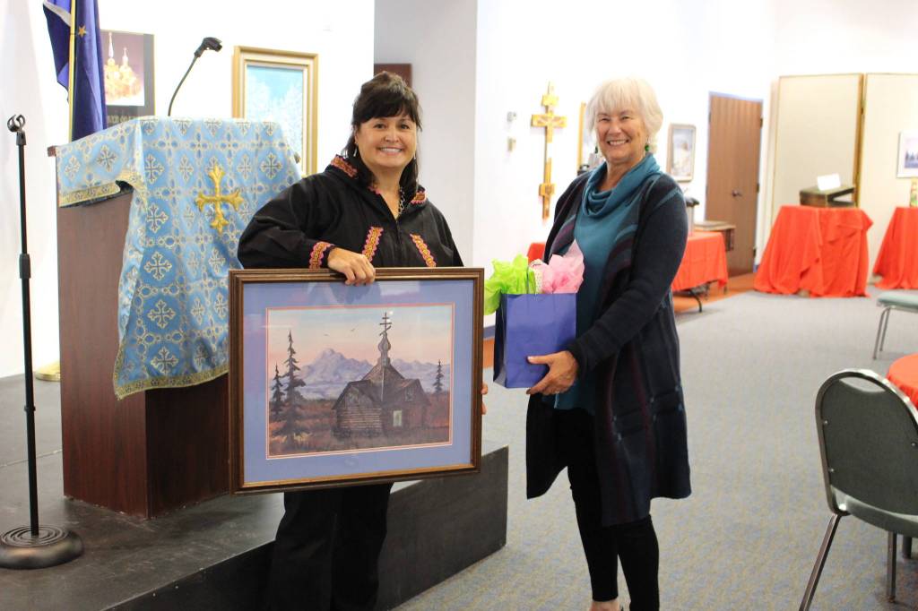 Sheri Buretta, the chairman of the board of the Chugach Alaska Corporation, presents a gift to Dorothy Gray, a lifelong member of the Holy Assumption of the Virgin Mary Russian Orthodox Church, during a celebration of the 125th anniversary of the church at the Kenai Visitor and Cultural Center on Sept. 4, 2020. (Photo by Brian Mazurek/Peninsula Clarion)