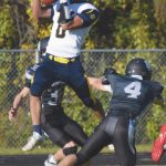 Homers Sly Gaona makes a touchdown catch in front of Nikiskis Jaryn Zoda and Gavin White on Friday, Sept. 11, 2020, at Nikiski High School in Nikiski, Alaska. (Photo by Jeff Helminiak/Peninsula Clarion)