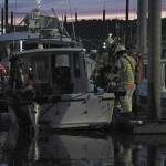 Firefighters finish putting out a fire on a 32-foot fiberglass boat on Friday, Sept. 11, 2020 at the Homer Harbor in Homer, Alaska. No one was onboard at the time and no one was injured. (Photo by Megan Pacer/Homer News)