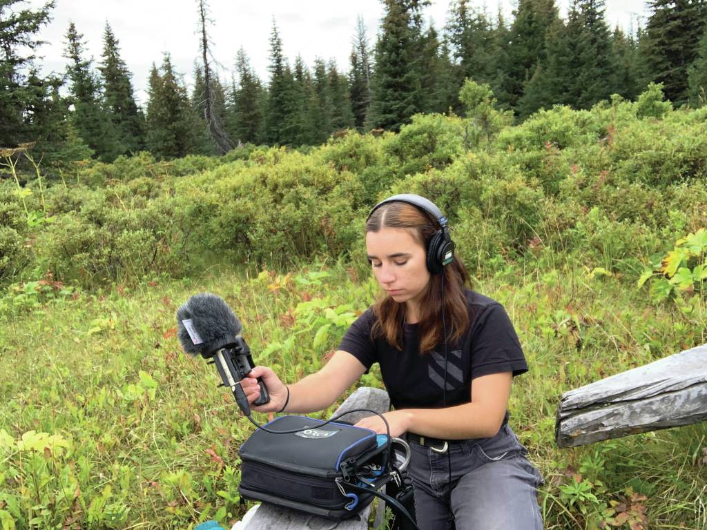 Lindsey Schneider records nature sounds for her radio play, Knife Skills, in August 2020 in Homer, Alaska. (Photo courtesy of Lindsey Schneider)