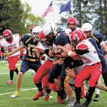 Homers River Mann is tackled by a group of Kardinals during a Saturday, Sept. 19, 2020 football game against Kenai Central High School at Homer High School in Homer, Alaska. The Mariners won 44-6. (Photo by Megan Pacer/Homer News)