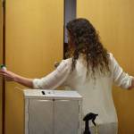 Kenai Deputy City Clerk Jacquelyn LaPlante adjusts cabinets behind a ballot box at the Kenai City Clerks office on Monday, Sept. 21, in Kenai, Alaska. (Ashlyn OHara / Peninsula Clarion)