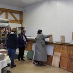 Linda Farnsworth-Hutchings and other members of the Soldotna 100+ Women Who Care group vote on which charity or nonprofit will receive their donations this quarter at the BuildUP nonprofit