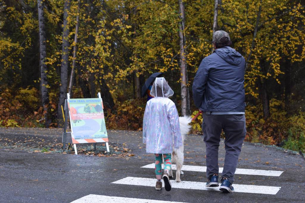 People are seen walking a dog at a Ski Hill Multi-use Trail head on Saturday, Sept. 26 just outside Soldotna, Alaska.