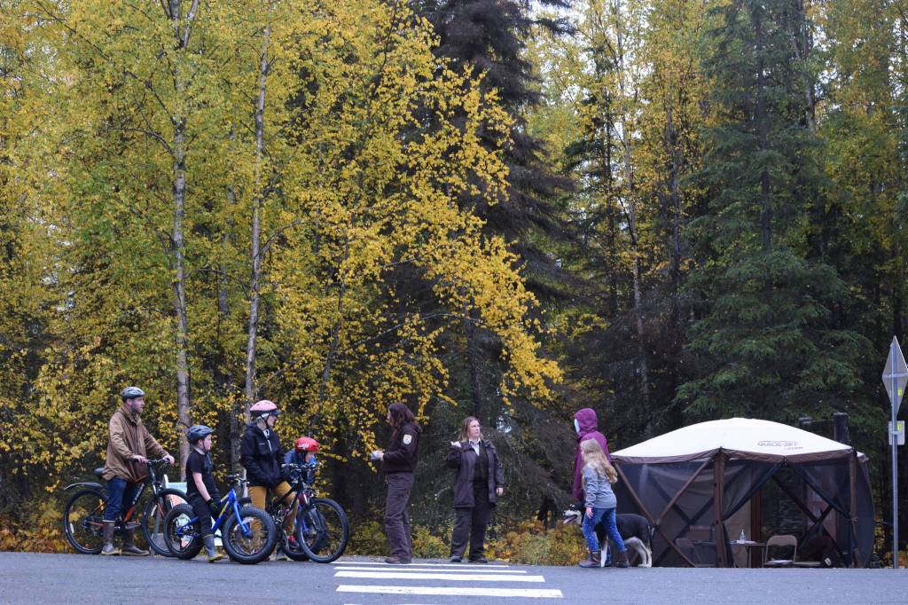 Michelle Ostrowski (fifth from left) and Leah Eskelin (third from right) talk to visitors at a Ski Hill Multi-use Trail head on Saturday, Sept. 26 just outside Soldotna, Alaska.                                Michelle Ostrowski (fifth from left) and Leah Eskelin (third from right) talk to visitors at a Ski Hill Multi-use Trail head on Saturday, Sept. 26 just outside Soldotna, Alaska.