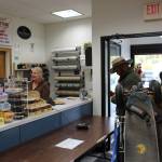 Noah Procter, center, and Brad Carver, right, of Solid Rock Bible Camp, pick up a set of newly repaired mountain boards from Beemuns Variety Ski and Bike Loft as Gaile Sutton, left, rings up the transaction in Soldotna, Alaska on Sept. 17, 2020. (Photo by Brian Mazurek/Peninsula Clarion)