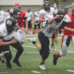 Nikiskis Caileb Payne leads a group of Nikiski players in chasing down Kenai Central quarterback Bridger Beck on Friday, Oct. 2, 2020, at Kenai Central High School. (Photo by Jeff Helminiak/Peninsula Clarion)