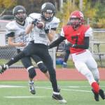Nikiskis Holden Warnke steps in front of teammate Jaryn Zoda and Kenai Centrals James Baisden for an interception Friday, Oct. 2, 2020, at Kenai Central High School in Kenai, Alaska. (Photo by Jeff Helminiak/Peninsula Clarion)