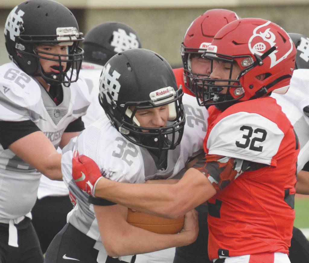 Nikiski running back Jaryn Zoda is stood up by Kenai Centrals Tucker Vann on Friday, Oct. 2, 2020, at Kenai Central High School in Kenai, Alaska. (Photo by Jeff Helminiak/Peninsula Clarion)