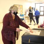 Marcia Heinrich casts her ballot for the municipal elections in Kenai, Alaska on Oct. 6, 2020. (Photo by Brian Mazurek/Peninsula Clarion)