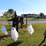 Photo by Brian Mazurek/Peninsula Clarion Julianna Desiderio, of Kenai, checks out a scarecrow designed by the Kenai Police Department during the fifth annual Kenai Fall Pumpkin Festival in Kenai on Saturday.