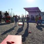 From left, Isabell Pijahn, Clark Douthit and Sawyer Douthit play a round of cornhole during the 5th annual Kenai Fall Pumpkin Festival in Kenai, Alaska on Oct. 10, 2020. (Photo by Brian Mazurek/Peninsula Clarion)