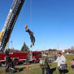 A scarecrow designed by the Kenai Fire Department is seen suspended from one of the fire engines during the 5th annual Kenai Fall Pumpkin Festival in Kenai, Alaska on Oct. 10, 2020. (Photo by Brian Mazurek/Peninsula Clarion)