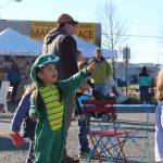 Adaline Meganaca points at a plane passing overhead during the 5th annual Kenai Fall Pumpkin Festival in Kenai, Alaska on Oct. 10, 2020. (Photo by Brian Mazurek/Peninsula Clarion)