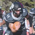 Nikiski's Koleman McCaughey rushes against Houston on Saturday, Oct. 10, 2020, at Nikiski High School in Nikiski, Alaska. (Photo by Jeff Helminiak/Peninsula Clarion)