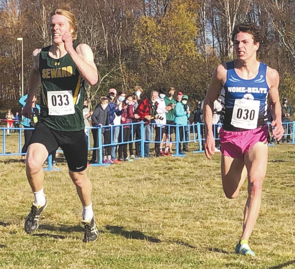 Sewards Max Pfeiffenberger outsprints Nomes Tobin Hobbs (30) to the line Saturday, October 10, 2020, at the ASAA cross-country running championships at Kincaid Park in Anchorage, Alaska. (Photo by Joey Klecka/For the Clarion)