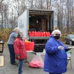 Volunteers distribute bags of food for Soldotna Residents thanks to a grant program from the city at the Soldotna United Methodist Church on Oct. 14, 2020. From left: Cosette Kilfoyle, Director of the Soldotna Food Pantry; Sandy Sandoval and Leroy Sandoval, Food Bank Volunteers; Kathy Carson, member of Christ Lutheran Church. (Photo by Brian Mazurek/Peninsula Clarion)