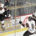 Kenai River Brown Bears forward Laudon Poellinger jumps on the boards to celebrate his first-period goal against the Fairbanks Ice Dogs with Brandon Lajoie and Ryan Reid at the Soldotna Sports Center in Soldotna, Alaska. (Photo by Jeff Helminiak/Peninsula Clarion)