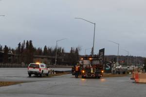 Crews work along the Sterling Highway over the Kenai River on Monday in Soldotna. (Photo by Ashlyn OHara/Peninsula Clarion)
