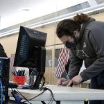 Ben Hohenstatt / Juneau Empire
Peter Sidmore fills out paperwork prior to voting early and in-person in the 2020 general election on Oct. 22. Election officials said the fourth day of early voting was slower than the three days when hundreds of voters showed up to vote in person. On this day, fewer than a dozen people had voted as of 8:45 a.m.
