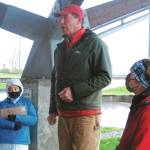 Alaska U.S. Senate candidate Al Gross speaks to supporters at an event at a downtown park in Juneau, Alaska, on Saturday, Oct. 31, 2020, as his wife, Monica Gross, at right, looks on. The event, held on a rainy, windy morning, is among those Gross is holding in the lead-up to the Nov. 3, 2020, general election, in which Gross, an independent running with Democratic backing, is facing Republican U.S. Sen. Dan Sullivan. (AP Photo/Becky Bohrer)