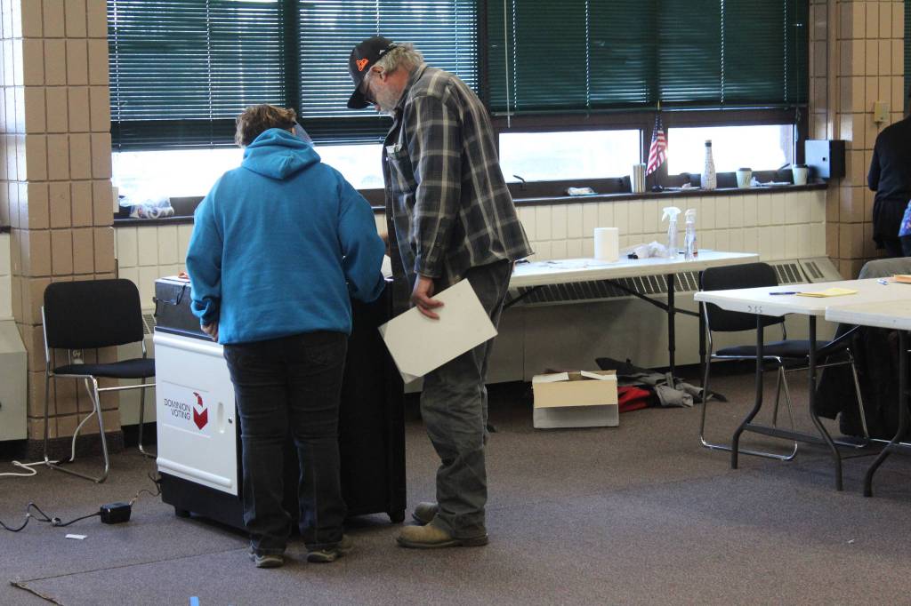 A poll worker helps a voter with their ballot at the Soldotna Regional Sports Complex on Tuesday, Nov. 3 in Soldotna, Alaska. (Photo by Ashlyn OHara/Peninsula Clarion)