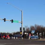 People are seen holding political signs at the intersection of Sterling Hwy. and Kenai Spur Hwy. on Tuesday, Nov. 3 in Soldotna, Alaska. (Photo by Ashlyn OHara/Peninsula Clarion)